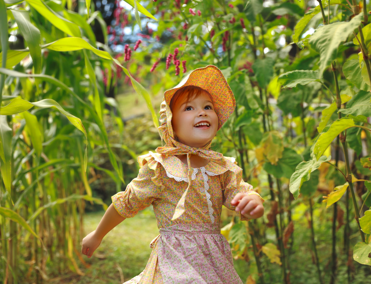 Little girl in field at The Farmer's Museum